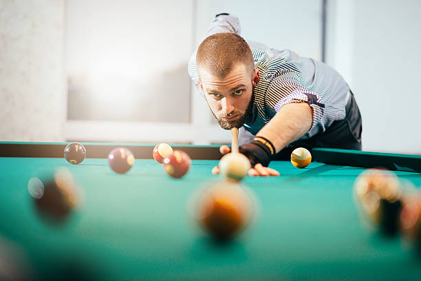 istock Portrait of billiard player aiming 613346512