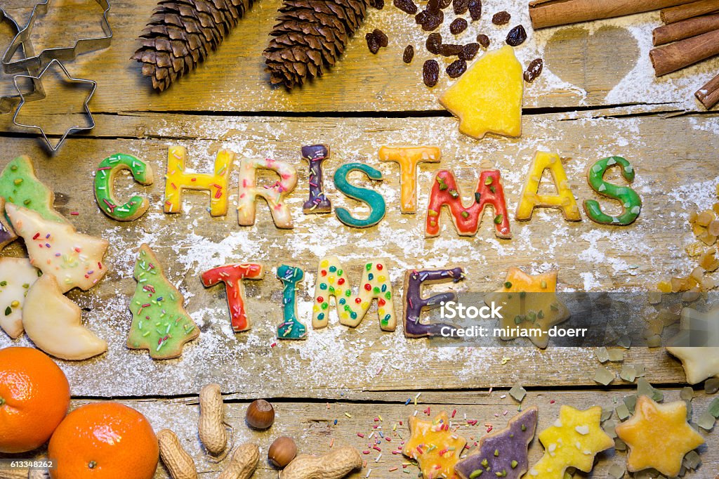 biscuit letters and christmas decoration on wood, christmastime biscuit letters and christmas decoration on wood, word christmastime Advent Stock Photo