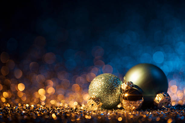 istock Christmas ornaments on defocused lights. Decorations Bokeh Blue Gold 613517776