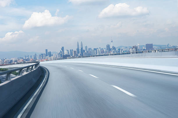 istock Highway overpass motion blur with mountain background . 613518444