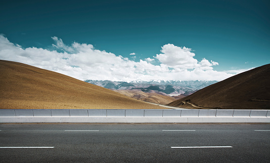Empty asphalt road and mountain background .