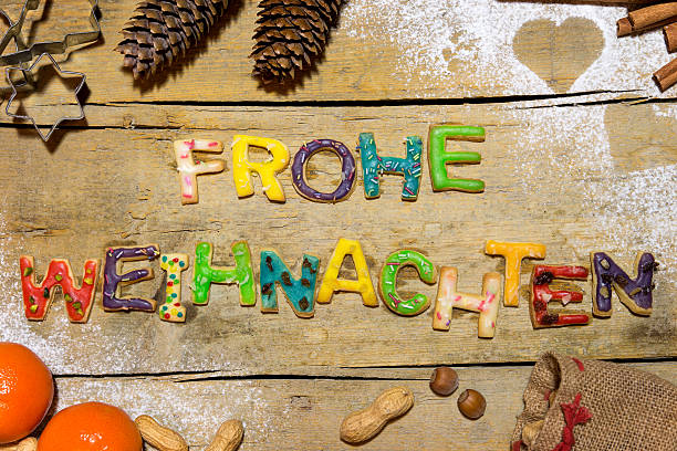 istock Cookie letters with christmas decoration on wooden table, german 613520092