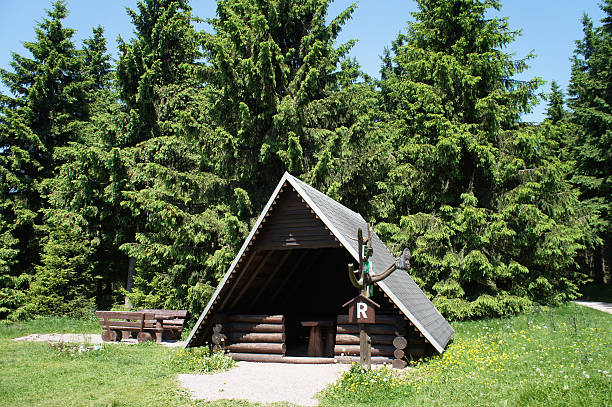 Shelter at the Rennsteig in the Thuringian Forest in Germany, hut and picnic area in front of a spruce forest, 