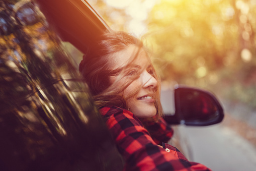 Smiling girl looking out of the car window