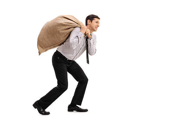 istock Businessman carrying a sack 613521606