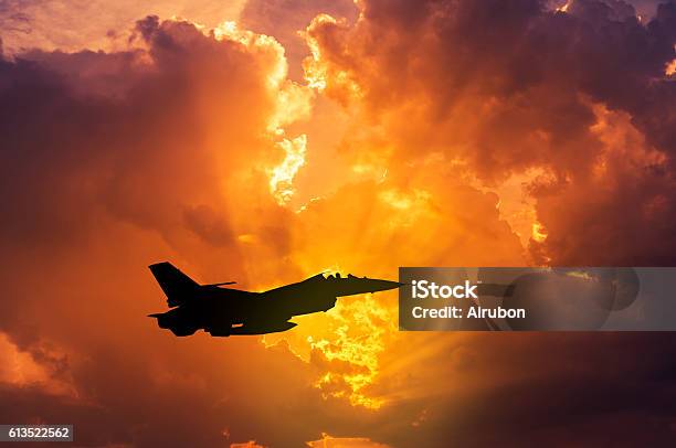 Silhouette F16 Military Aircraft Flying On Sunset Stock Photo - Download Image Now - Fighter Plane, F-16 Fighting Falcon, Military Airplane