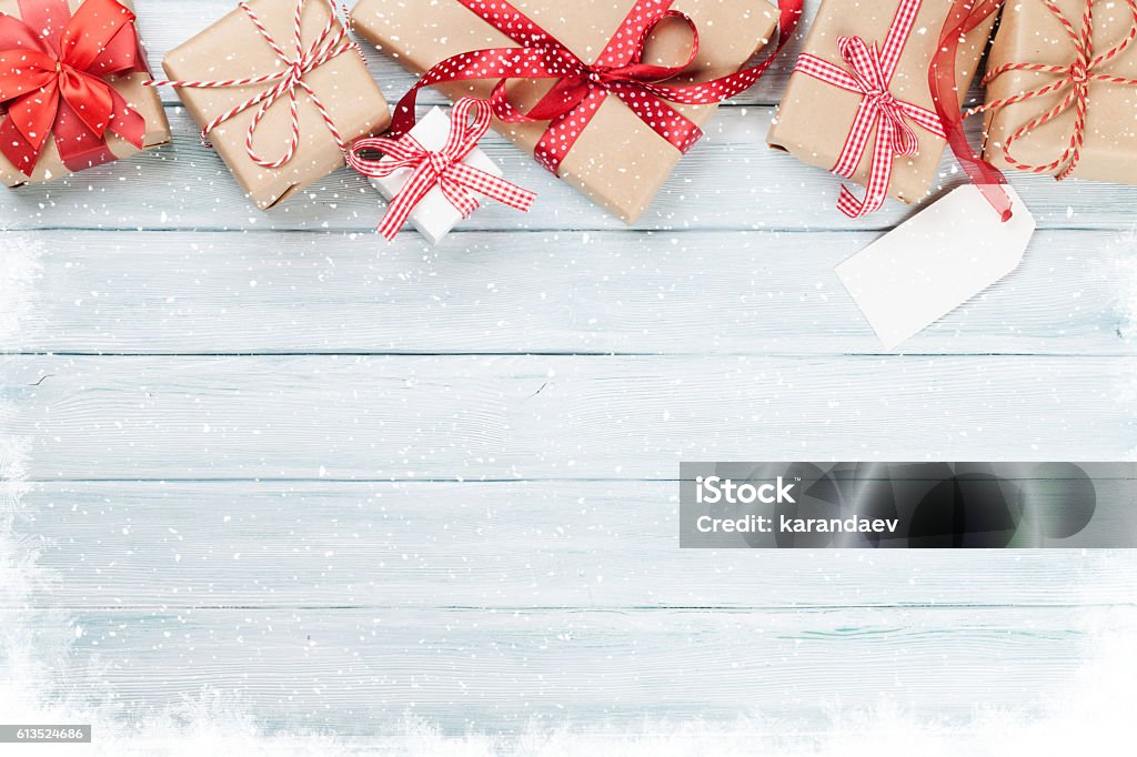 Christmas wooden background with gift boxes and snow Christmas wooden background with gift boxes and snow. Top view with copy space for your text Christmas Present Stock Photo