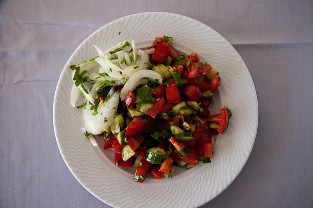 istock Salad with tomatoes and cucumbers in the plate 613525526