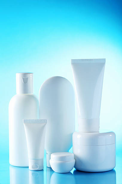 istock White cosmetic bottles on a blue background 613525830