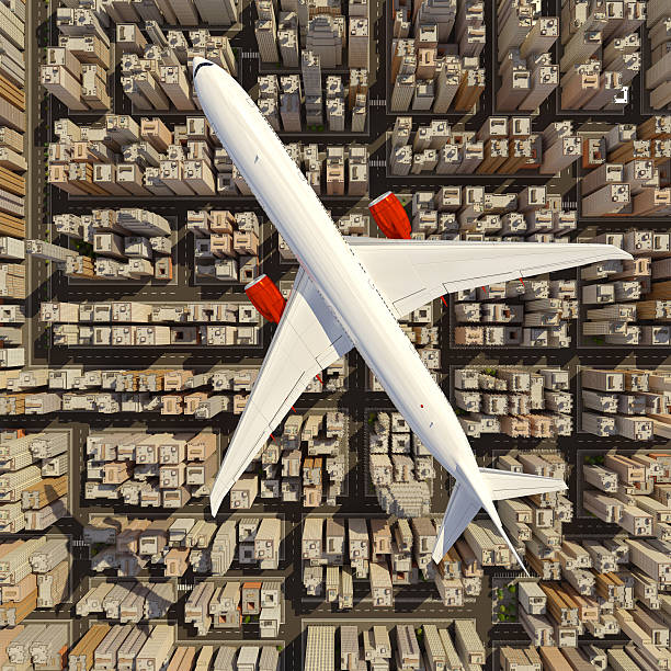 istock Big white airplane above the huge city. 613528862