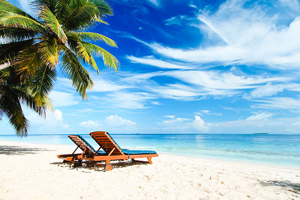 istock Two beach chairs on tropical vacation 613529976