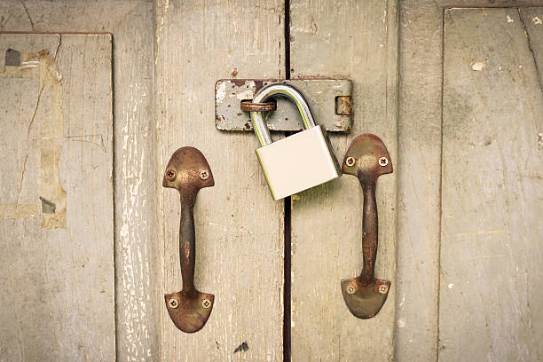 istock Master key is lock on old wood door vintage tone. 613530124