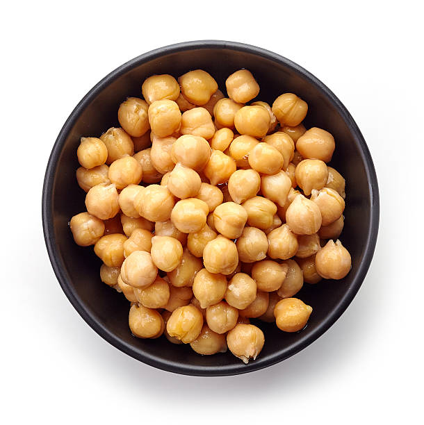 istock Black bowl of chickpeas isolated on white, from above 613532878