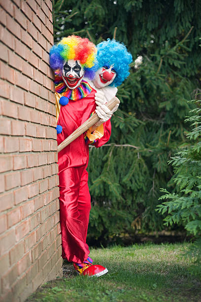 istock Creepy Clowns Peeking Around A Corner 613533256