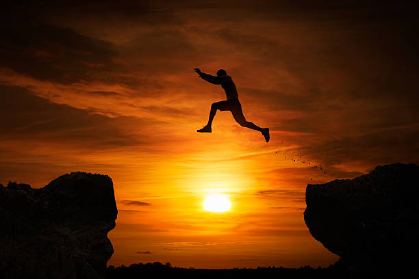 jumping over abyss - adrenaline imagens e fotografias de stock