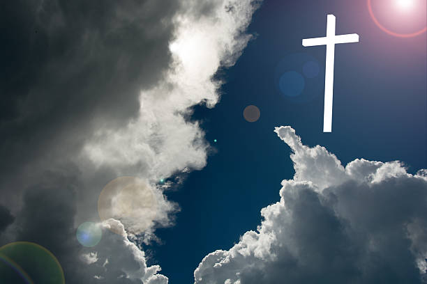 istock Christ has  risen Cross at sunrise  dark clouds-  copy space 613535376