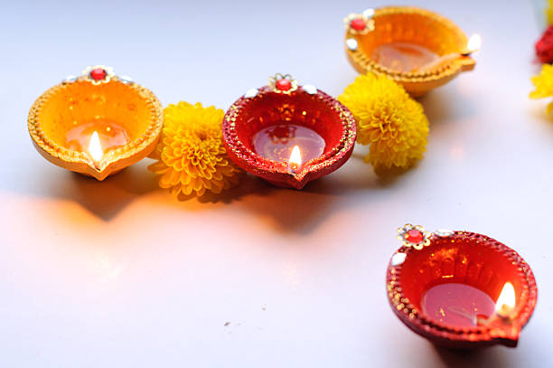 istock diya lamps lit during diwali celebration with flowers and sweets 613535890
