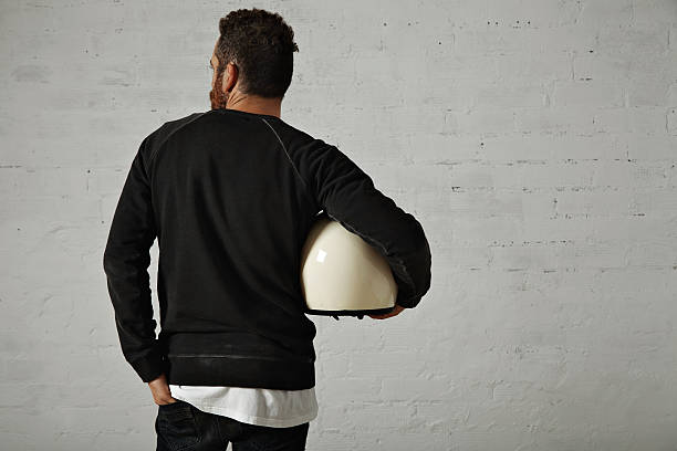 istock Young man with motorcycle helmet 613538122