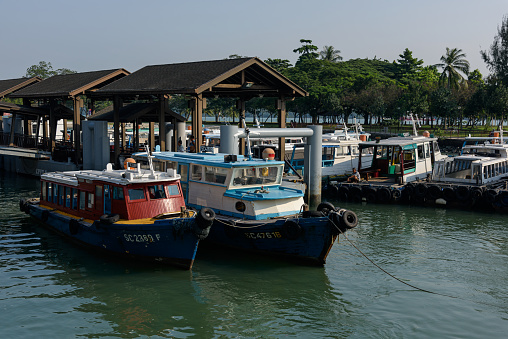 Singapore, Singapore - September 24, 2016: Bumboats at Changi Ferry Terminal in Singapore. From this terminal, bumboats can be taken for destinations such as Pulau Ubin or Penggerang in Johor Malaysia. The image was captured in the morning.