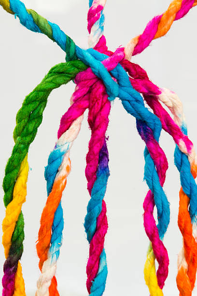 istock Connected group concept as many different ropes tied and linked 613540888