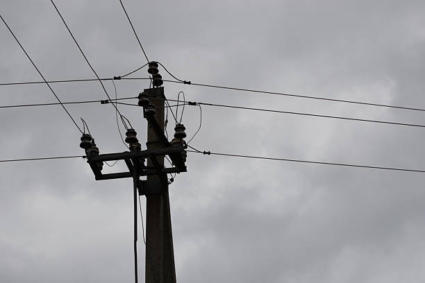 istock High voltage pillars on the background of cloudy sky 613541404