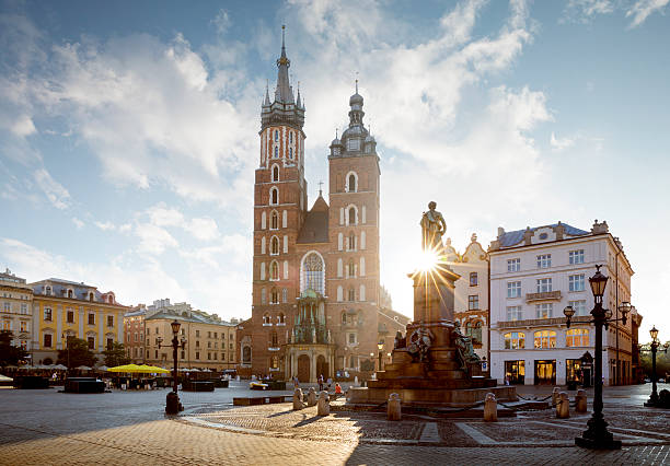 Panorama of Krakow Main Square, Poland Panorama of old city center with Adam Mickiewicz monument and St. Mary's Basilica in Krakow krakow photos stock pictures, royalty-free photos & images