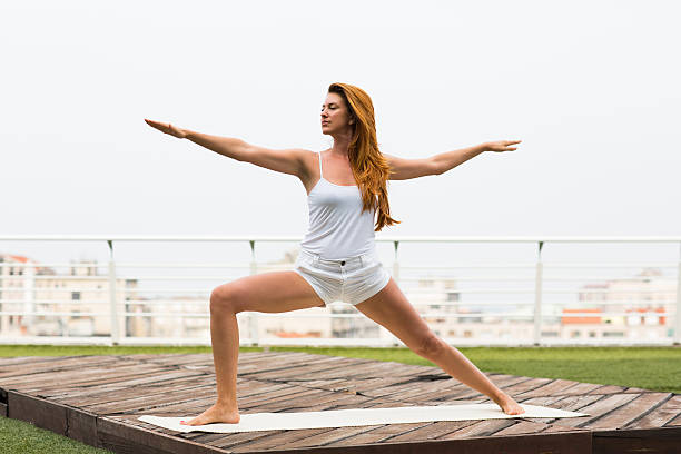 istock Beautiful woman doing yoga outdoors on a rooftop terrace 613542508