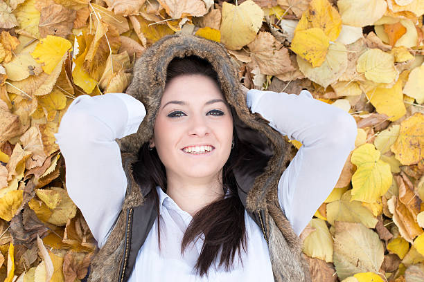 istock Young woman on autumn leaves. 613542798