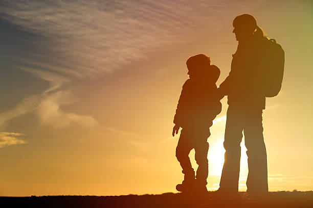 istock mother and son travel at sunset 613543100