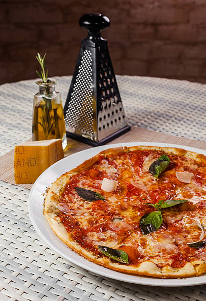 istock pizza with basil on a white plate on the table 613543222