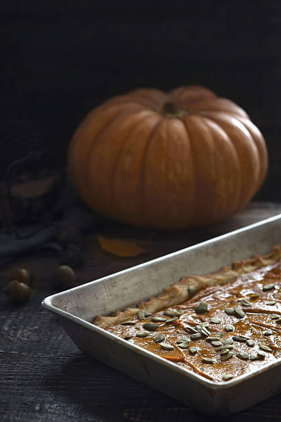 istock Pumpkin pie on the  wooden table vertical 613543224