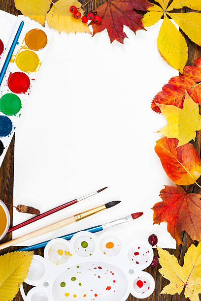 istock Composition with sheet of white paper, paints, brushes and autum 613545426