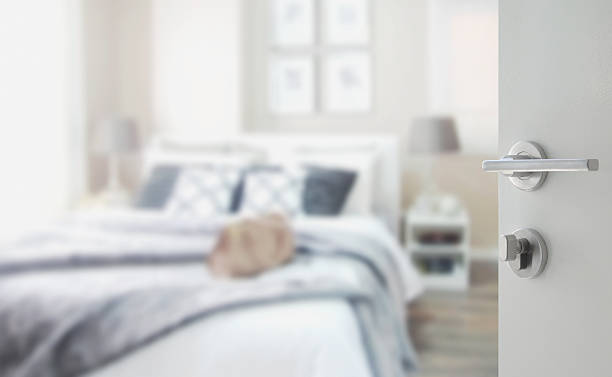 istock opened white door to blurred bedroom with bed 613546062