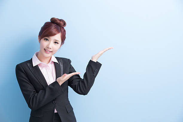 istock business woman show something 613546126