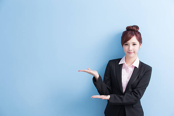 istock business woman show something 613546190