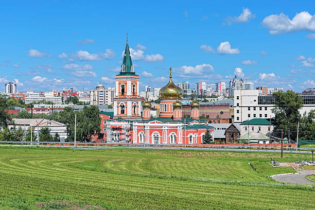 Znamensky Cathedral in Barnaul, Russia Barnaul, Russia. Znamensky Cathedral (Church of the icon of Our Lady of the Sign) on the background of the central part of the city. western siberia stock pictures, royalty-free photos & images