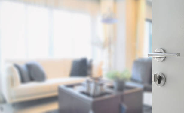 istock opened white door to modern living room interior 613548056
