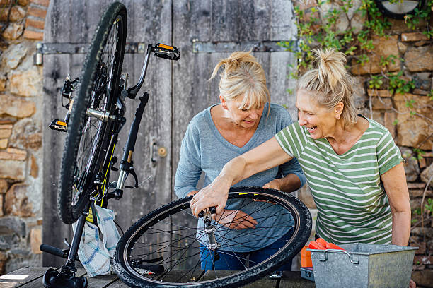 istock Senior Women Repairing a Bicycle 613549046
