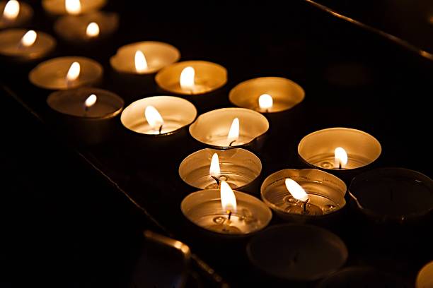 istock Candles in a dark church 613549350