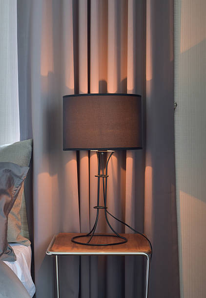 istock Black shade reading lamp next to bed 613549672