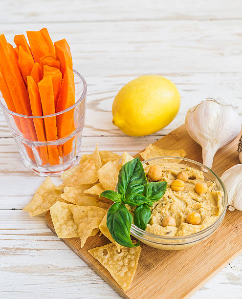 istock Fresh homemade organic hummus with pita cheaps and basil 613549832