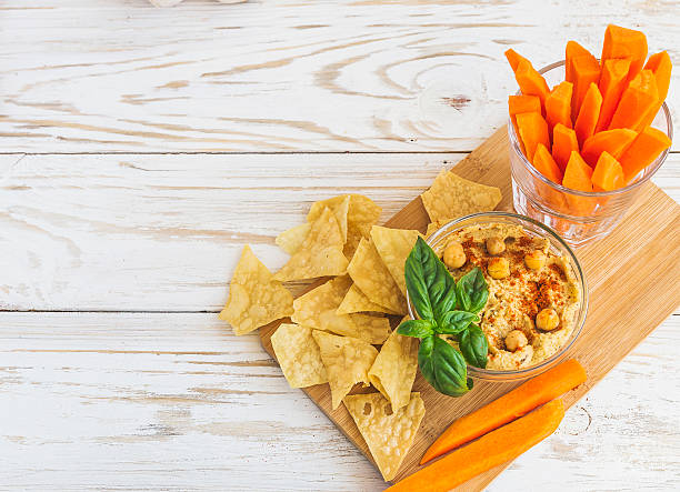 istock Fresh homemade organic hummus with pita cheaps and basil 613550124