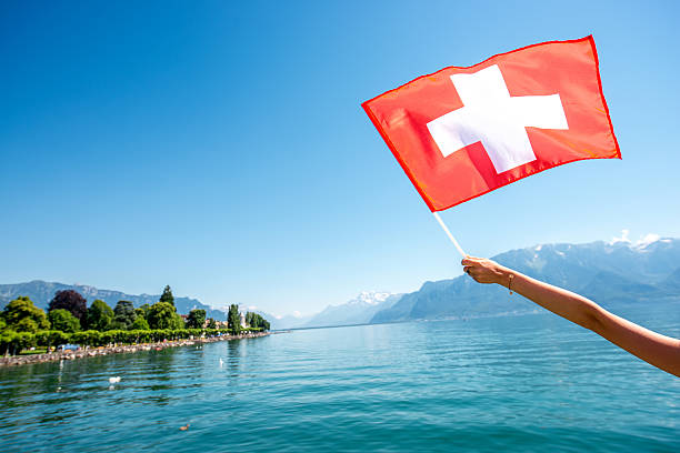 istock Swiss flag on the lake background 613550236