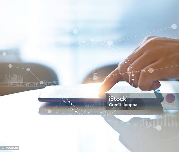 Hand Of Stock Investment Using Smartphone For Checking Worldwide Stock Photo - Download Image Now