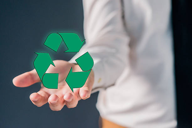 istock Businessman or manager holding   green recycling icon 613551102