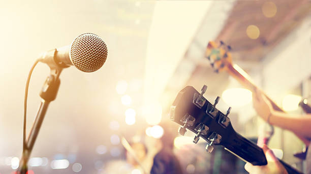 Guitarist on stage, soft and blur concept Guitarist on stage, soft and blur concept microphone photos stock pictures, royalty-free photos & images