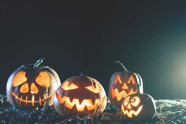 istock Halloween pumpkins at wood background. 613552758