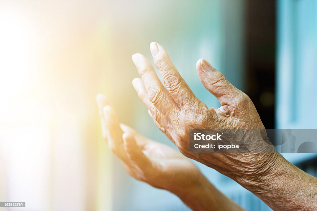 Elderly woman hands praying with peace of mind and faithfully. Praying Stock Photo