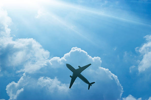 istock Airplane in the blue sky and cloud at sunrise 613552834