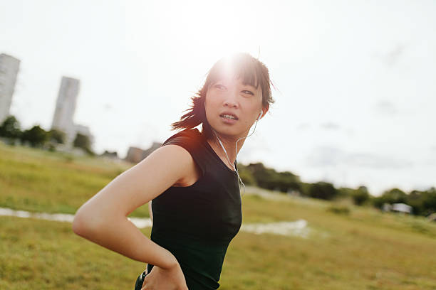 istock Fitness female on field glancing back 613553612